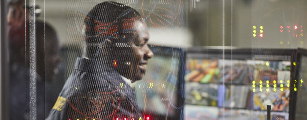 G4S security guard in front of monitors