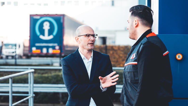 Kuehne + Nagel director speaking with a G4S officer