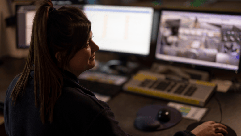 A security professional checking monitors in a room