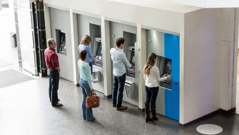People queuing in front of ATM machines