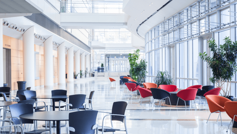 Empty cafeteria in a building with tables and chairs