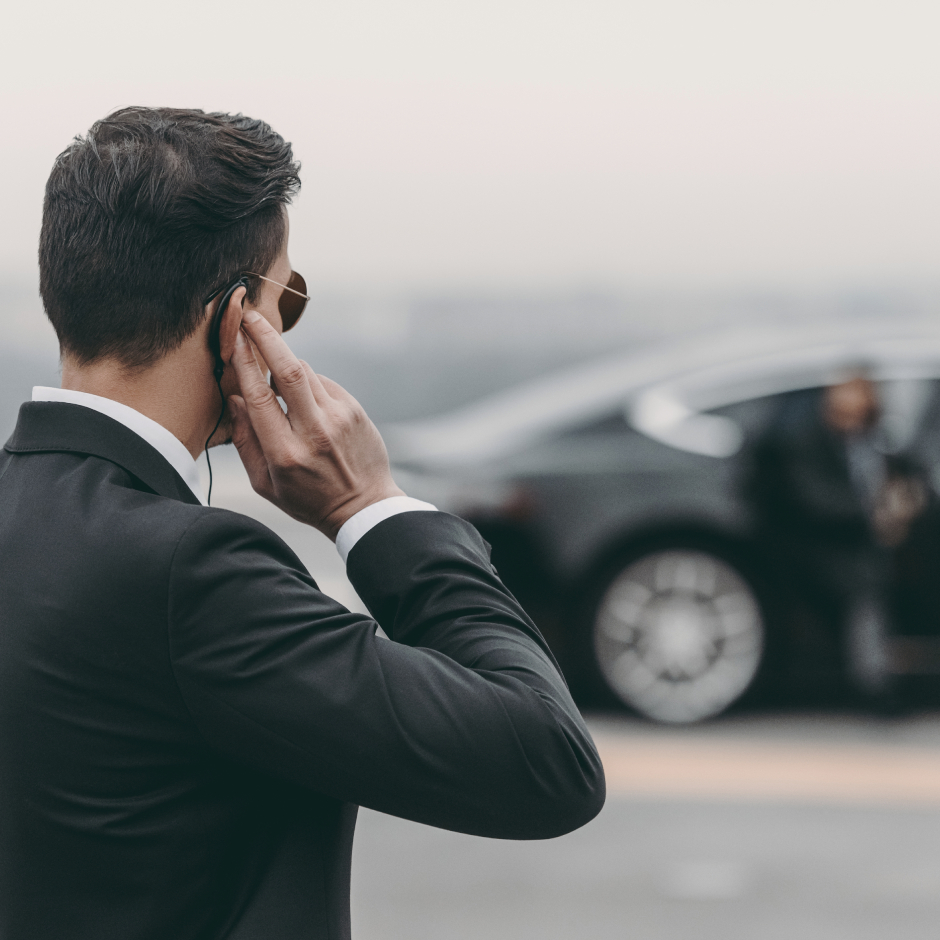 Stock image of a close protection officer touching his earpiece