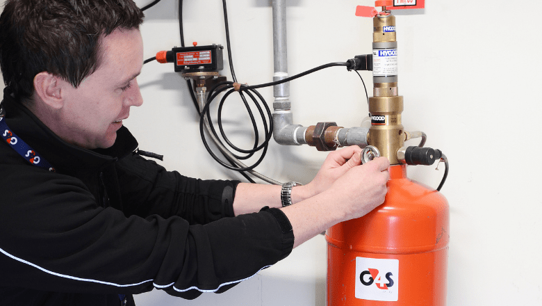 A G4S fire security professional demonstrating how to use the fire suppression systems