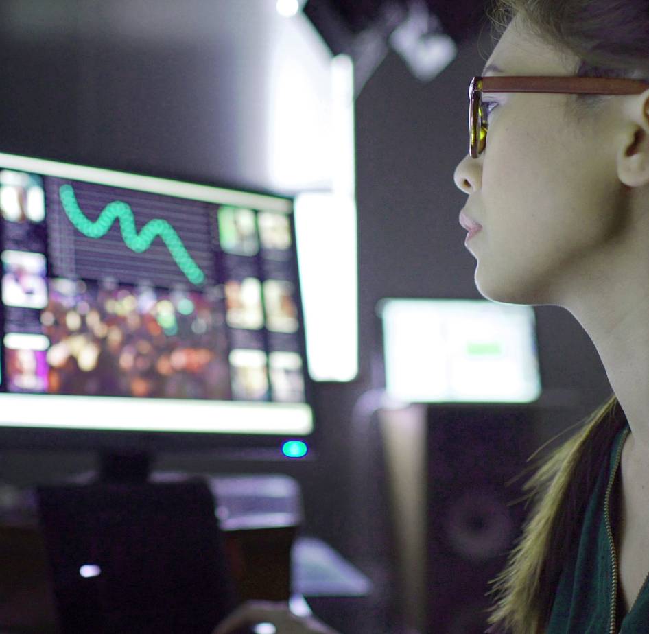 A female security officer looking at data on a computer screen