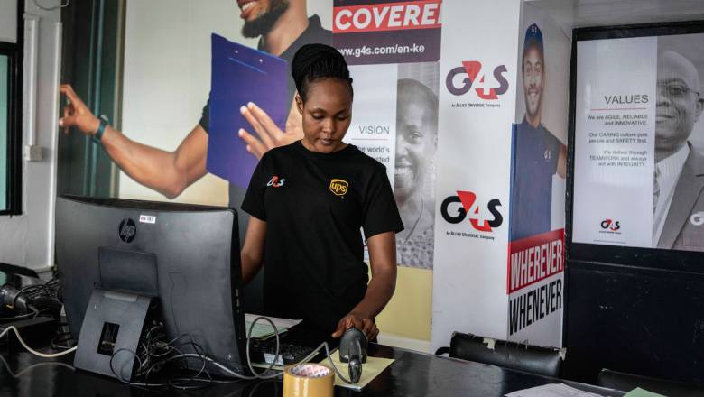 A G4S employee at a retail depot in Nairobi wearing a co-branded top
