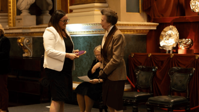 Heather Page Vice President of Global Learning and Development with Princess Royal on the stage