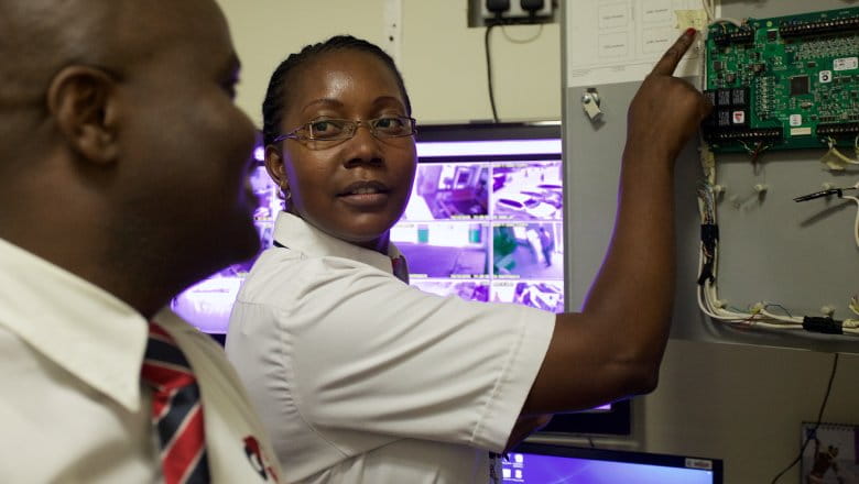 G4S employees inspecting a circuit board