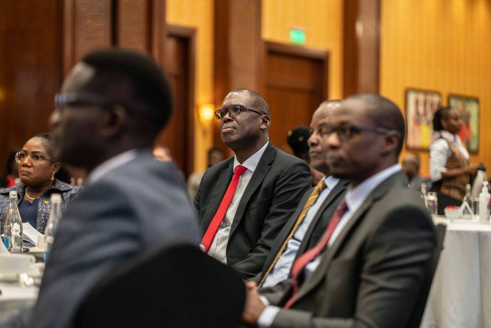 G4S Kenya Managing Director Laurence Okelo sat at a table listening to a speech