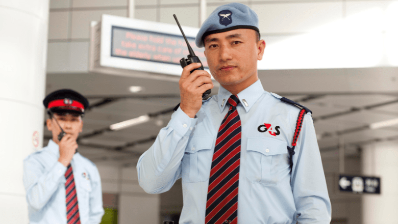 Security guards on duty holding radio devices