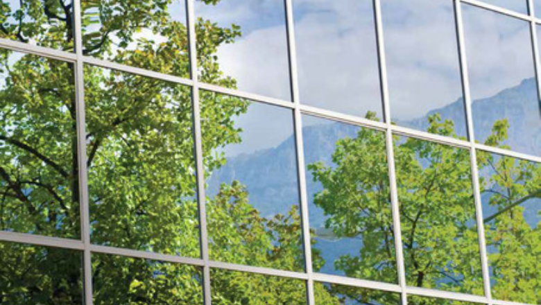 Reflection of trees on the windows of buildings