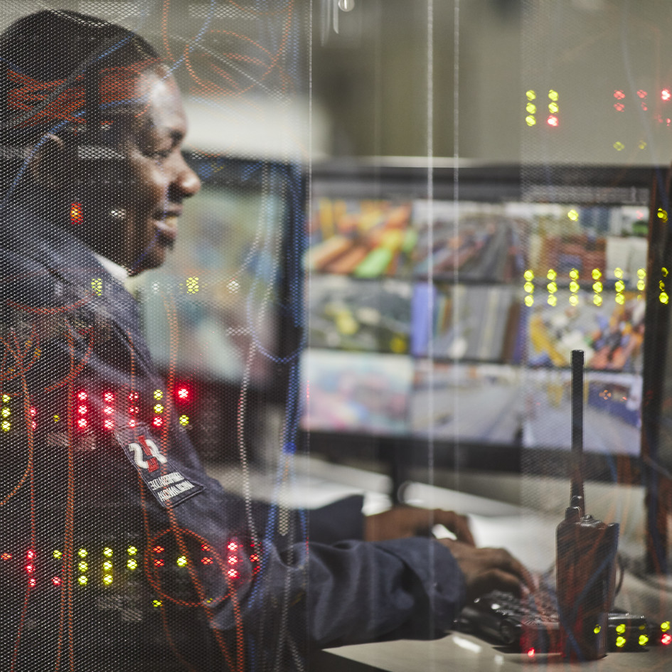 Security personnel in front of monitors