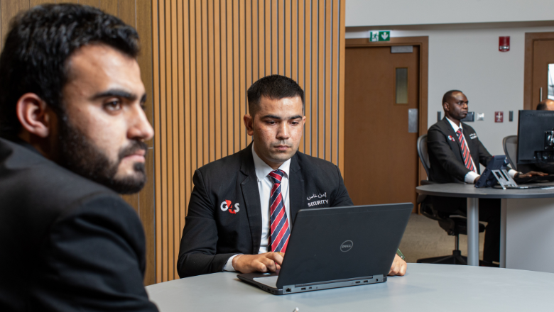 Security professionals sitting in front of their laptops