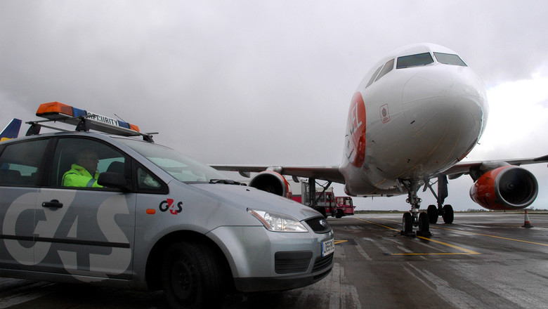 G4S car next to a plane