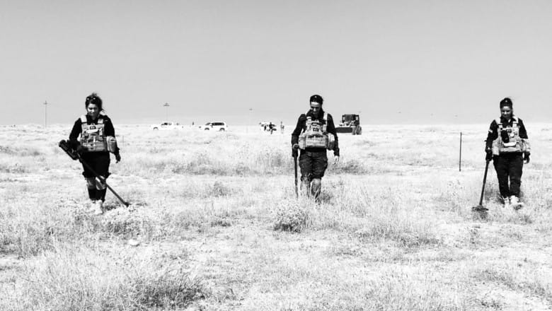 Demining work clearing ISIS explosives in Sinjar Northern Iraq - photo shows three G4S employees carrying out search work