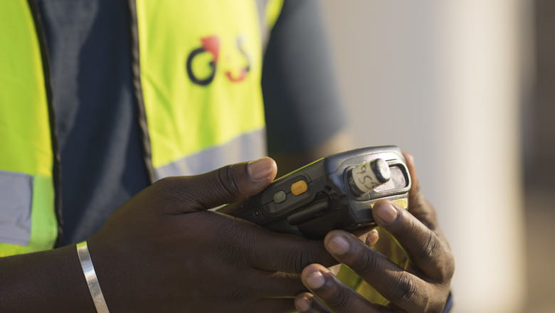 G4S officer with a handheld device