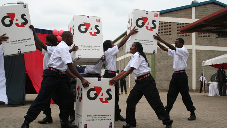 G4S Malawi employees moving cartons in teams
