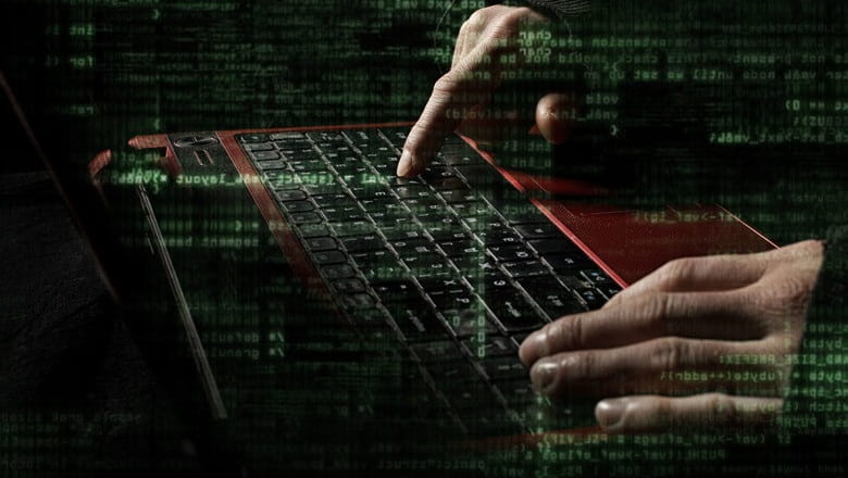 Cyber criminal typing on a keyboard