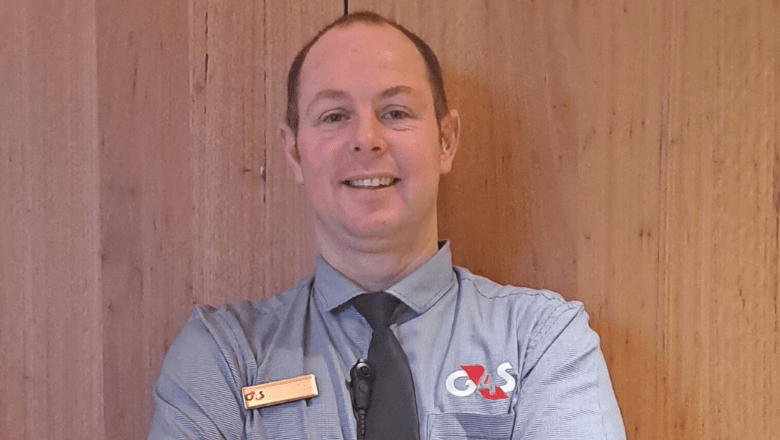 A G4S Custody Officer looks at the camera smiling