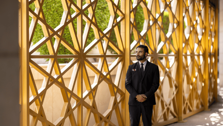 A men standing in front of a geometric background wall
