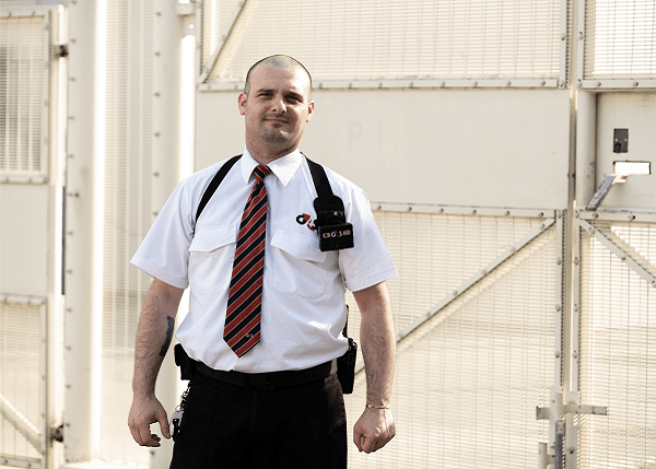 G4S male staff member standing in front of correctional facility