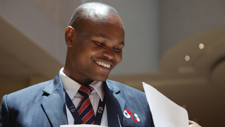 G4S employee smiling looking at papers