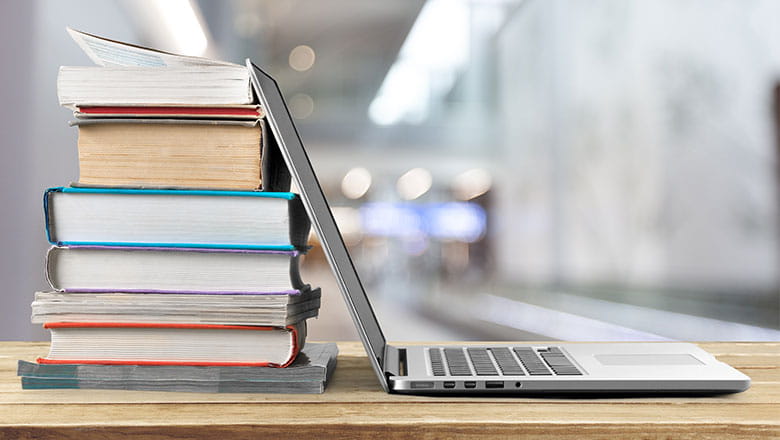 Laptop leaning on books