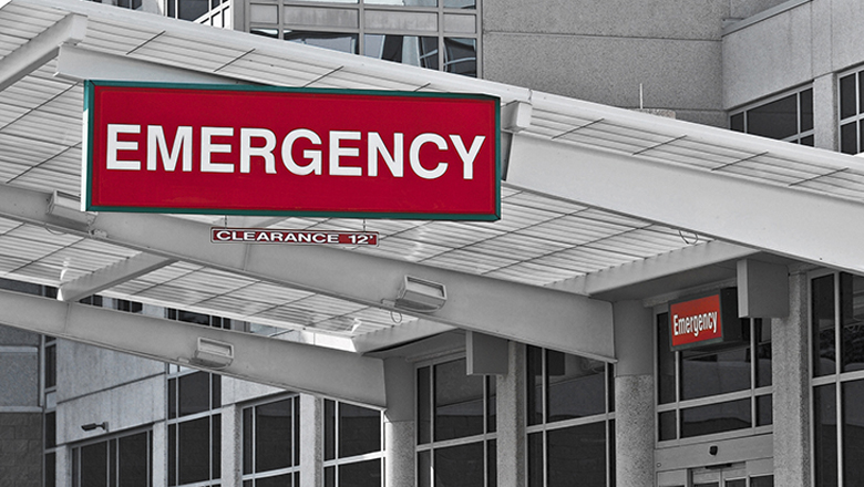 A red emergency board hanging in front of a white building