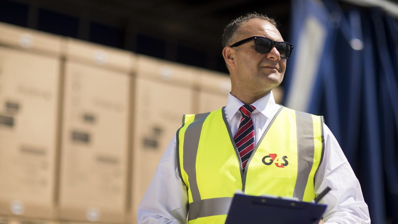 Security guard checking boxes in lorry
