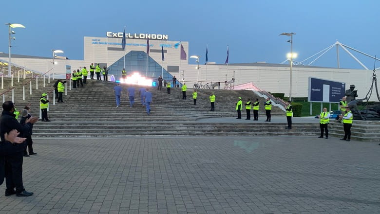 G4S guards give a guard of honour to NHS staff outside the NHS Nightingale Hospital for Covid-19 patients. 