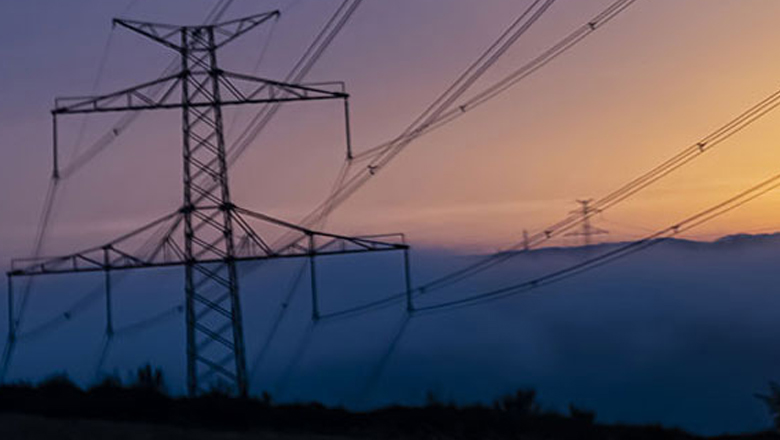 Large utility poles under sunset