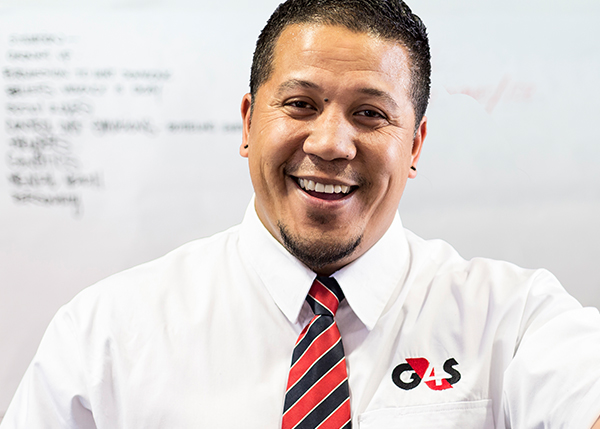 G4S employee in white shirt smiling