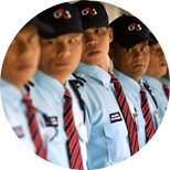 Thailand G4S males standing in a line wearing G4S light blue uniform