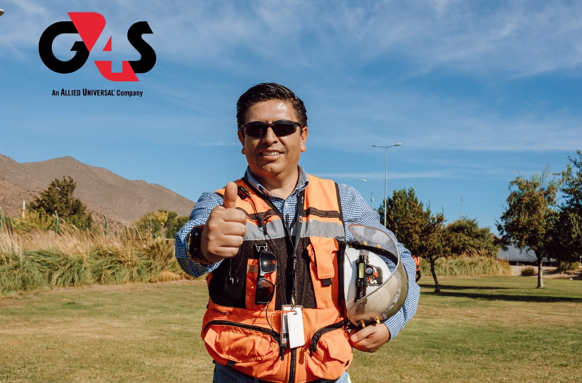 Blackboard under lights with a man in the background